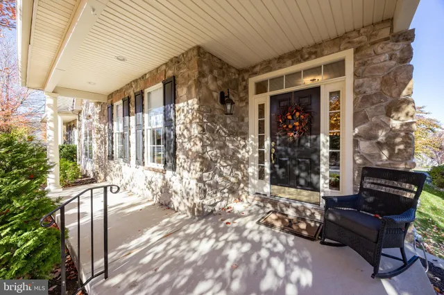 a view of a patio with table and chairs and potted plants with wooden floor and fence