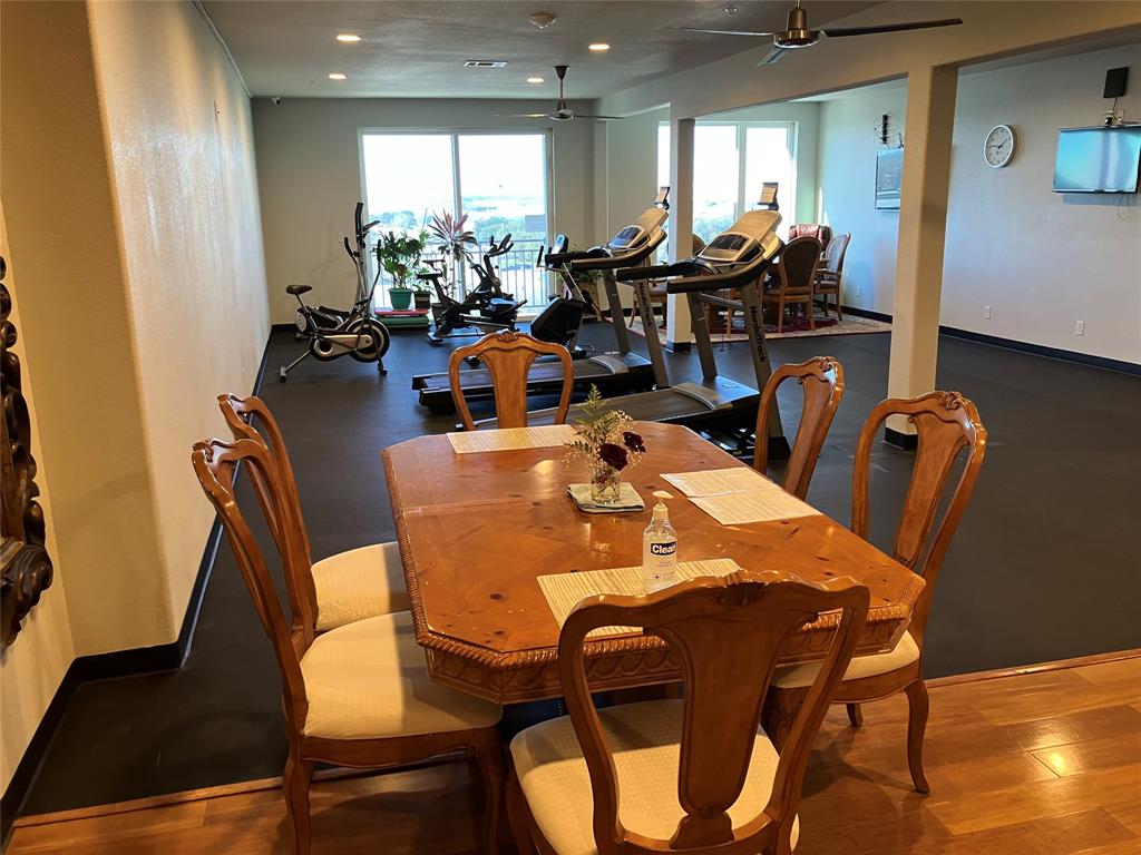 1220 West Trinity Mills Road, Unit 5009 Carrollton, TX 75006 - Photo 21 of 25 a view of a dining room with furniture and a large window
