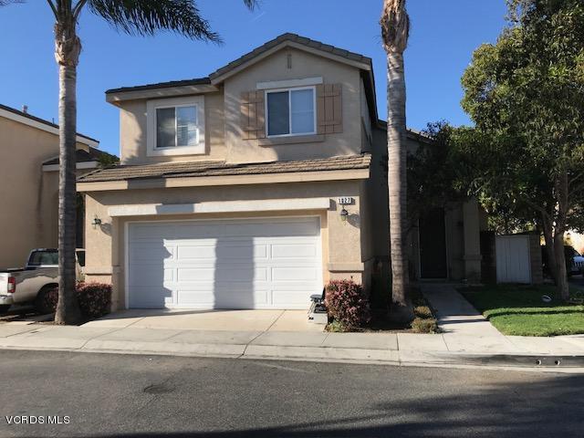 1027 Corte Primavera Oxnard, CA 93030 - Photo 1 of 17 a house that has a clock on it with a small yard