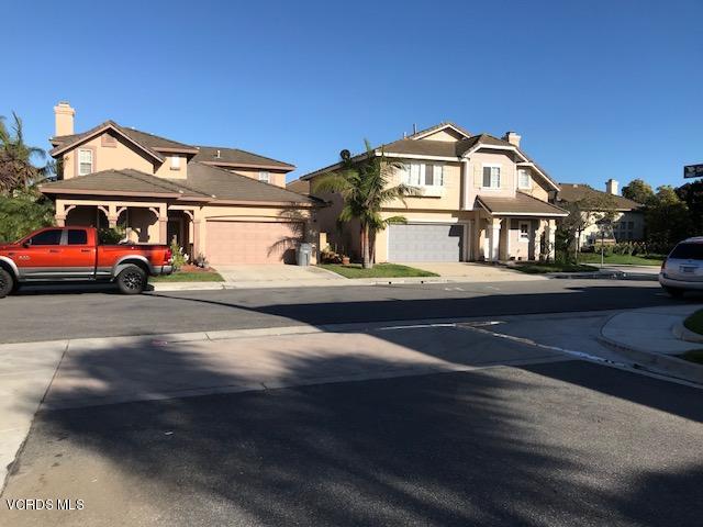 1027 Corte Primavera Oxnard, CA 93030 - Photo 15 of 17 a front view of a house with a yard