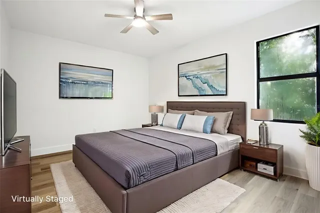 a bedroom with a large bed and a window