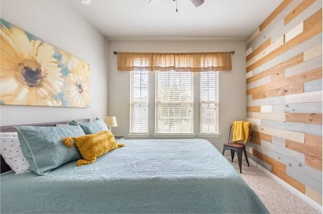 a bedroom with a bed and a window