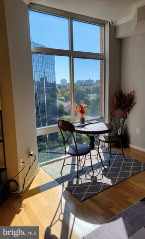 a work room with furniture and a floor to ceiling window