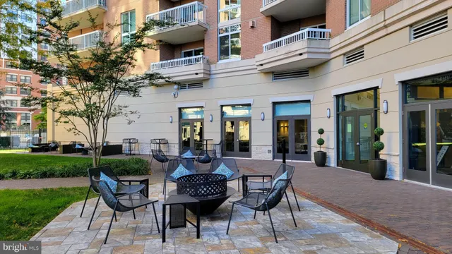 a view of a patio with table and chairs and potted plants