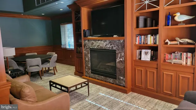 a living room with furniture a rug and a fireplace