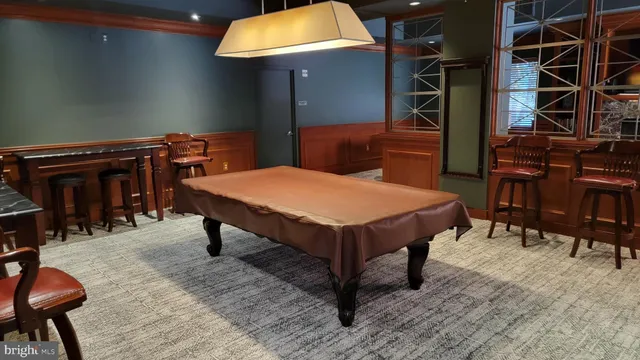 a room with table chairs and wooden floor