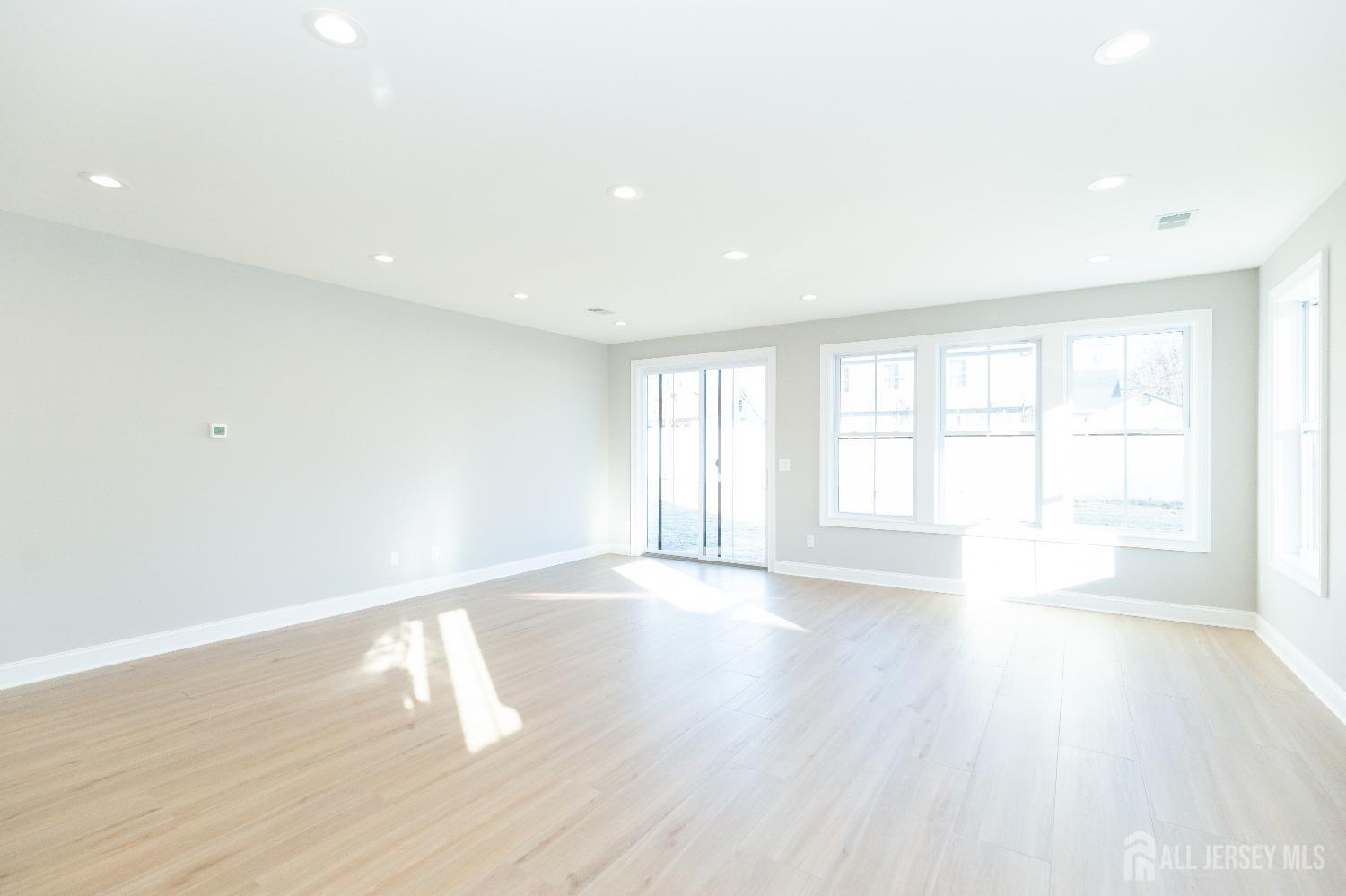 24 Parkerson Road Edison, NJ 08817 - Photo 14 of 56 a view of an empty room with wooden floor and a window