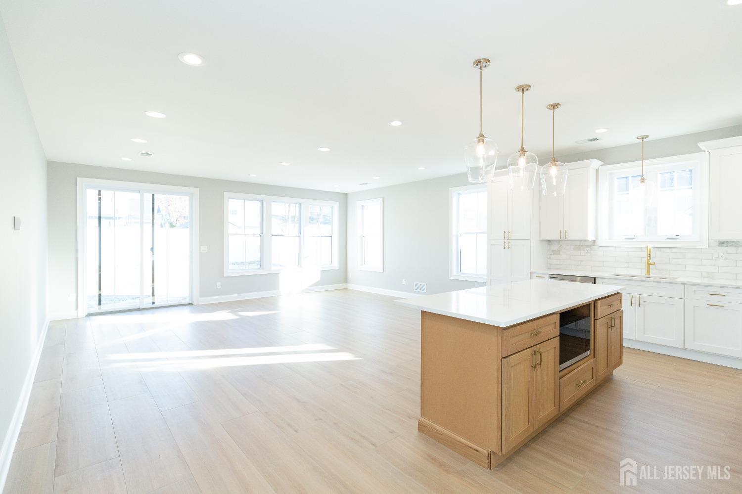 24 Parkerson Road Edison, NJ 08817 - Photo 15 of 56 a large kitchen with stainless steel appliances granite countertop a stove a sink and white cabinets with wooden floor