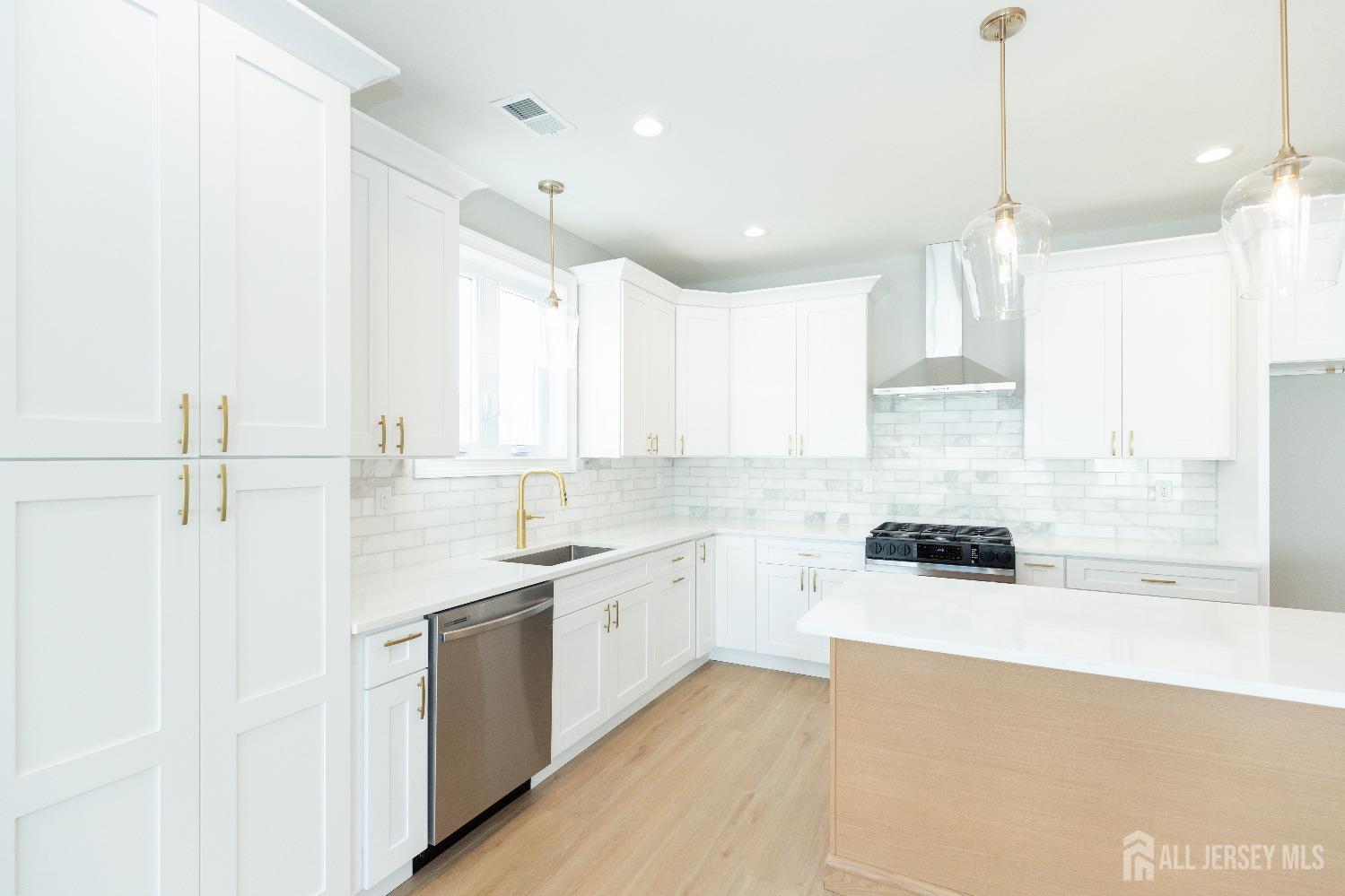 24 Parkerson Road Edison, NJ 08817 - Photo 17 of 56 a kitchen with a sink window and cabinets