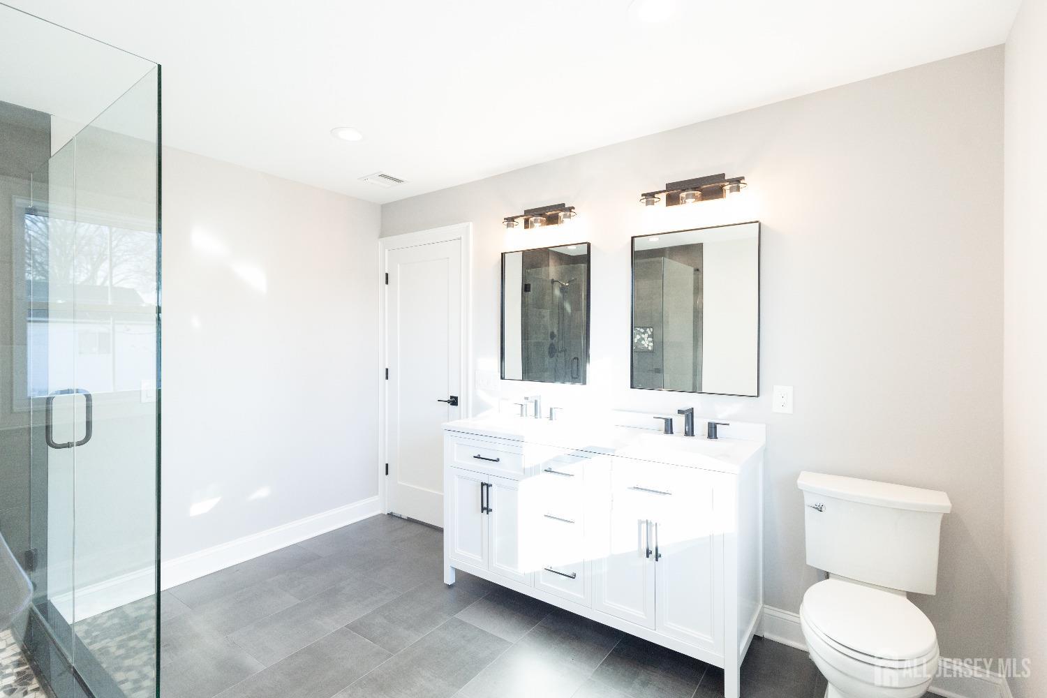 24 Parkerson Road Edison, NJ 08817 - Photo 35 of 56 a bathroom with a double vanity sink mirror and toilet