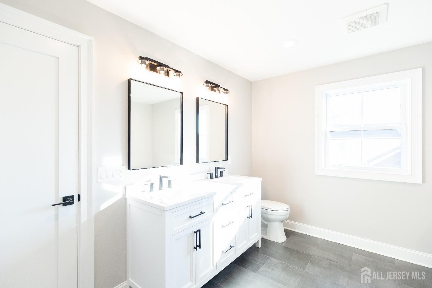 24 Parkerson Road Edison, NJ 08817 - Photo 36 of 56 a bathroom with a double vanity sink mirror and toilet