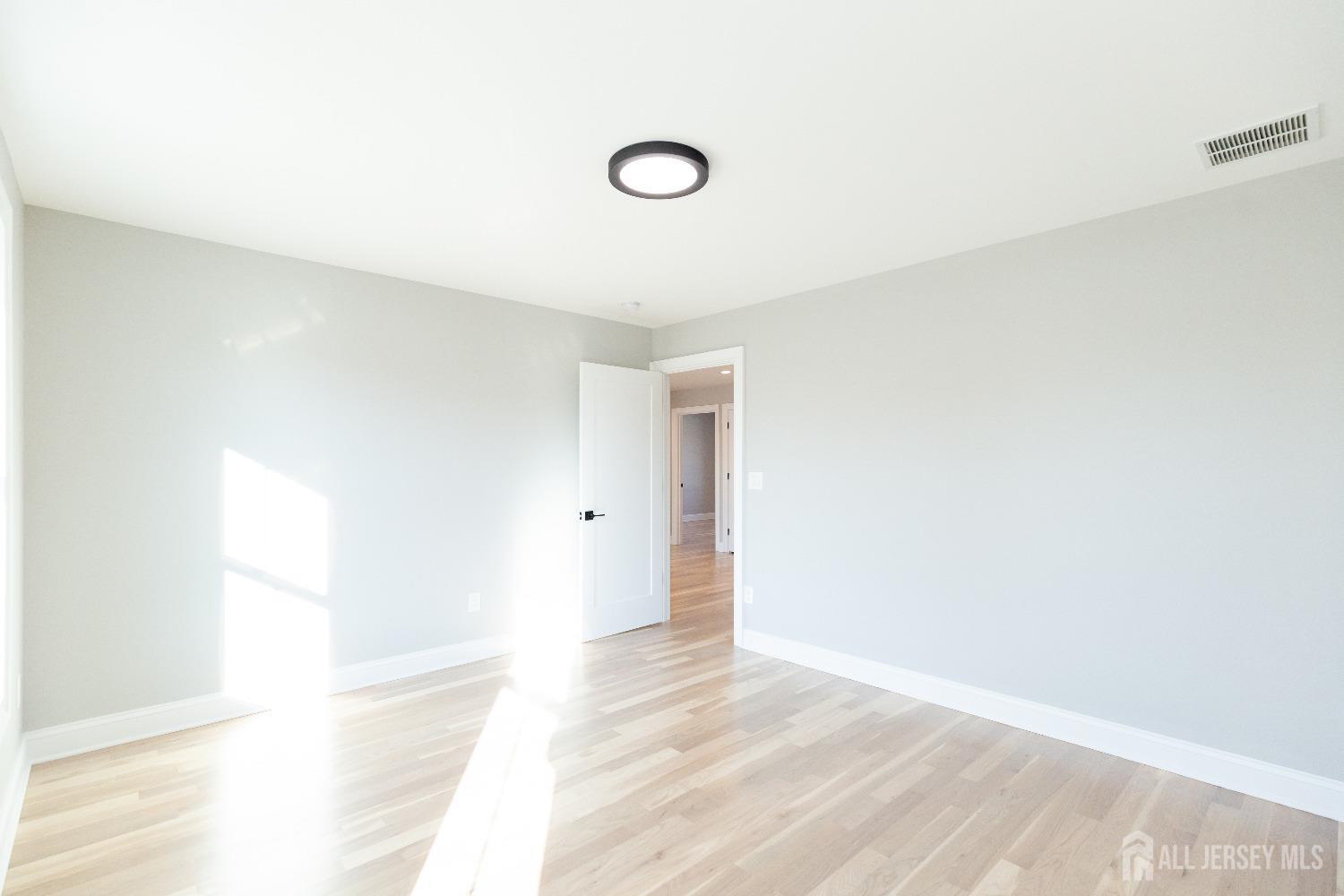 24 Parkerson Road Edison, NJ 08817 - Photo 39 of 56 a view of a livingroom with wooden floor