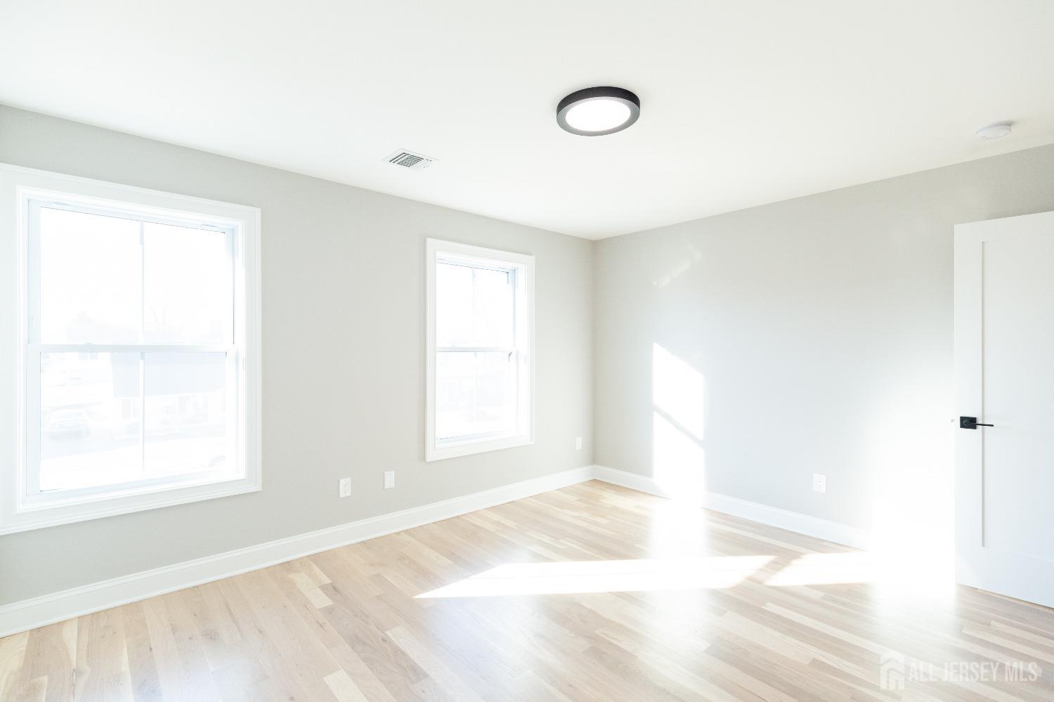 24 Parkerson Road Edison, NJ 08817 - Photo 40 of 56 a view of an empty room with wooden floor and a window