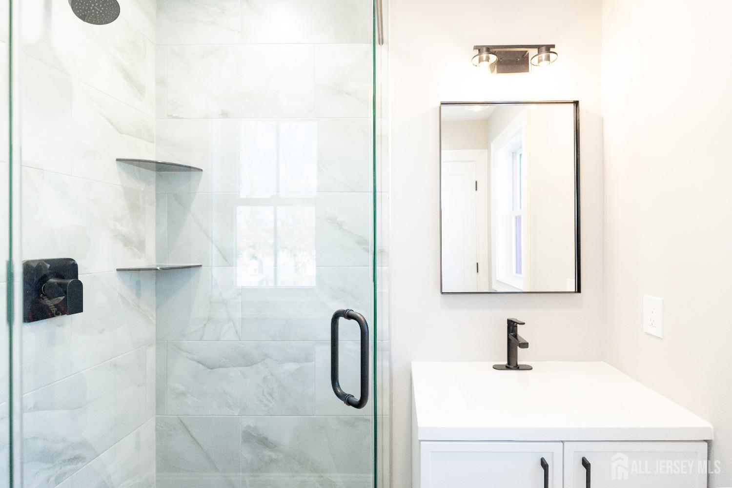 24 Parkerson Road Edison, NJ 08817 - Photo 45 of 56 a bathroom with a sink vanity and a mirror