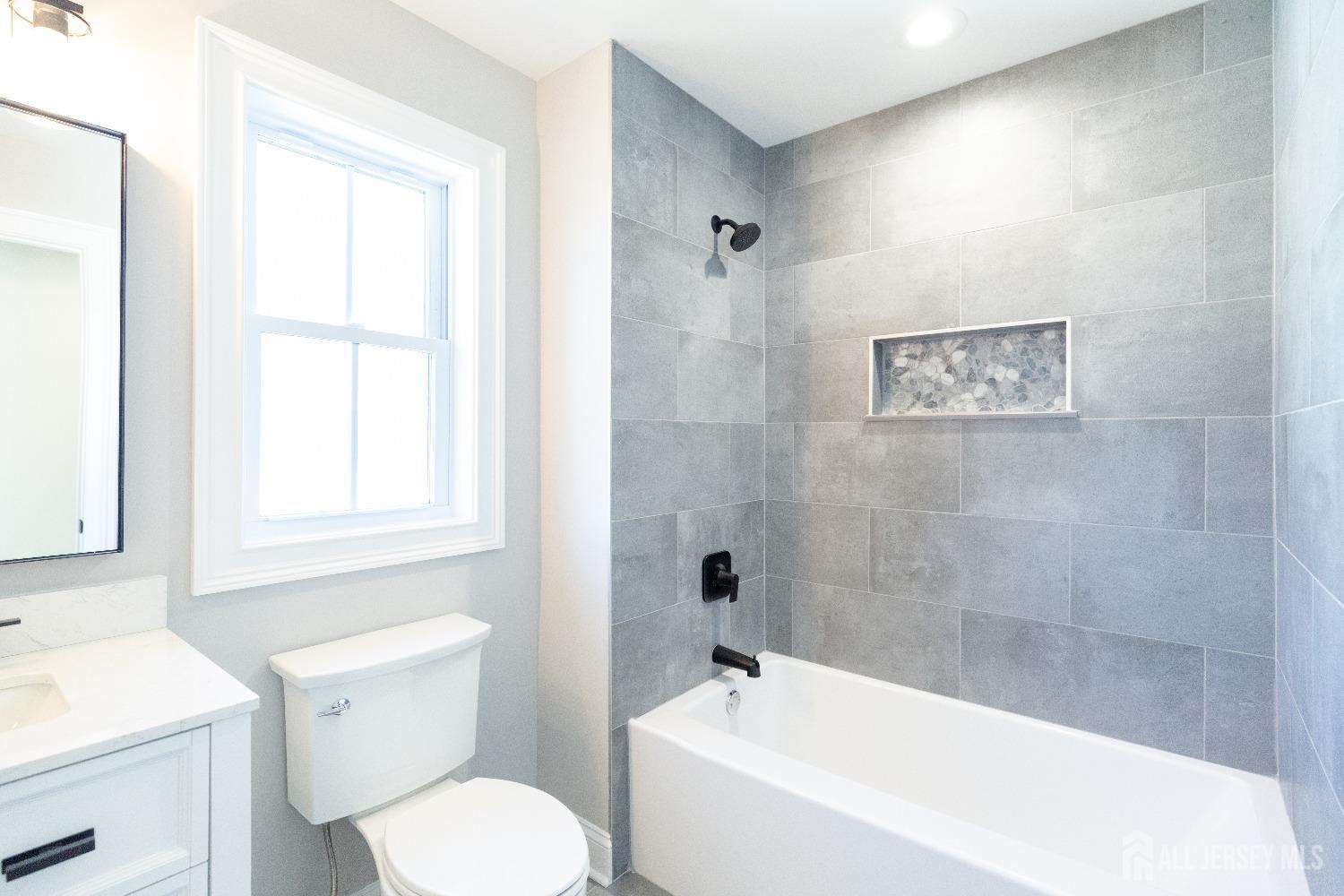 24 Parkerson Road Edison, NJ 08817 - Photo 52 of 56 a bath room with a toilet a bath tub and a sink