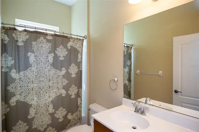 a bathroom with a shower and a sink