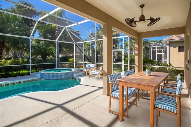 a view of a patio with a table chairs and a backyard