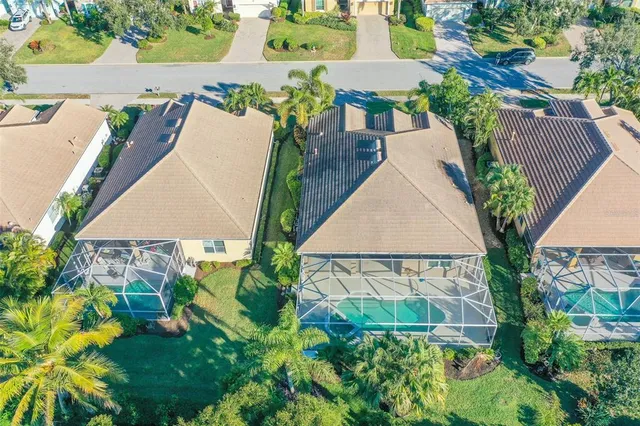 an aerial view of a house with outdoor space and a lake view