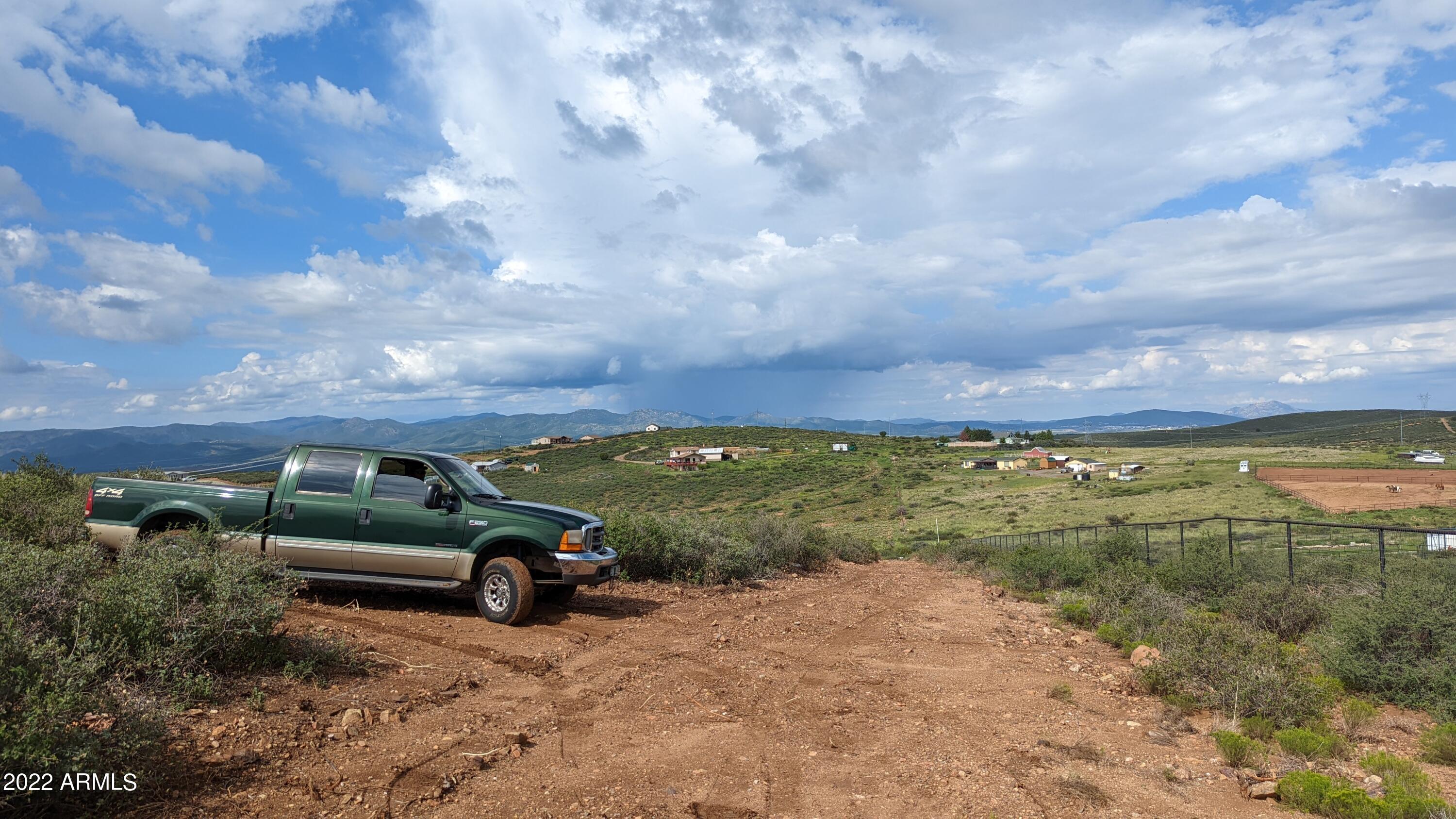 0 East Leprechaun Road, Unit 24K & 024L Dewey, AZ 86327 - Photo 9 of 13 a view of a car in front of a houses
