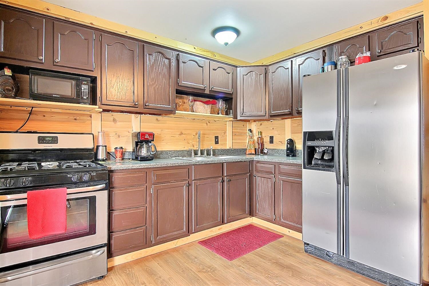 742 Fremont Road Valparaiso, IN 46385 - Photo 6 of 10 a kitchen with stainless steel appliances granite countertop a refrigerator stove and cabinets