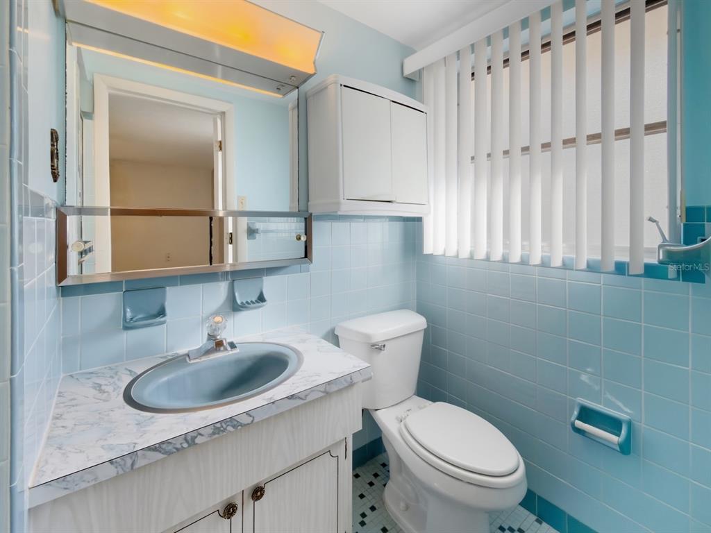 7903 Valmy Lane Port Richey, FL 34668 - Photo 22 of 40 a bathroom with a sink a toilet and a mirror