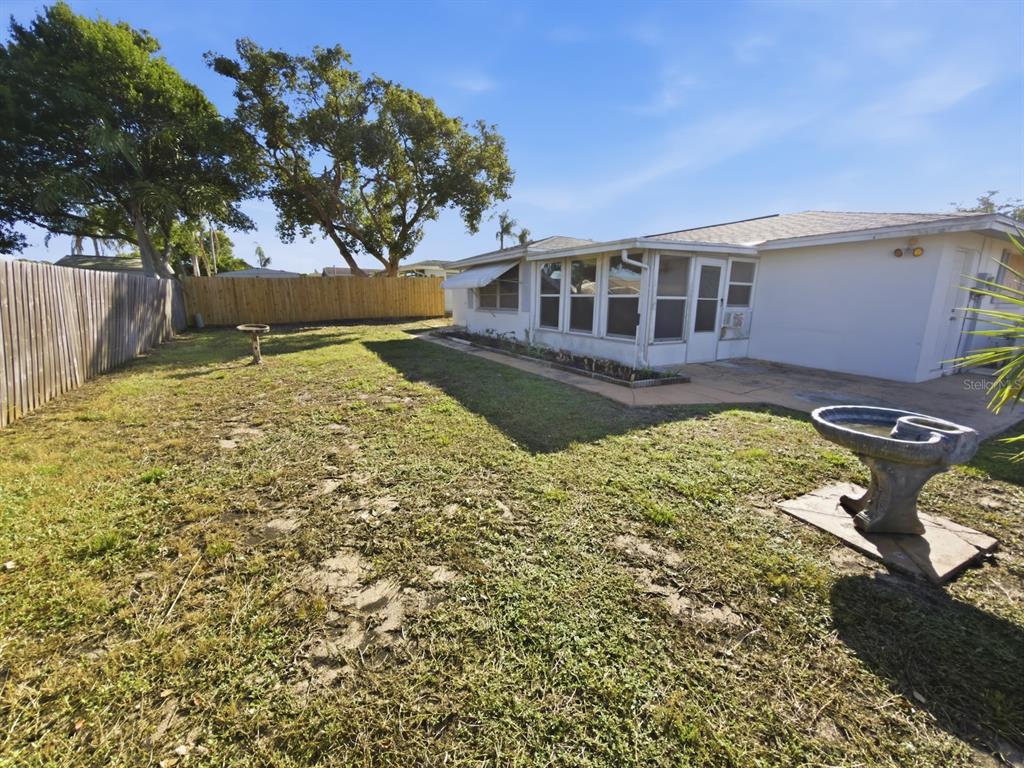 7903 Valmy Lane Port Richey, FL 34668 - Photo 33 of 40 a front view of a house with a yard