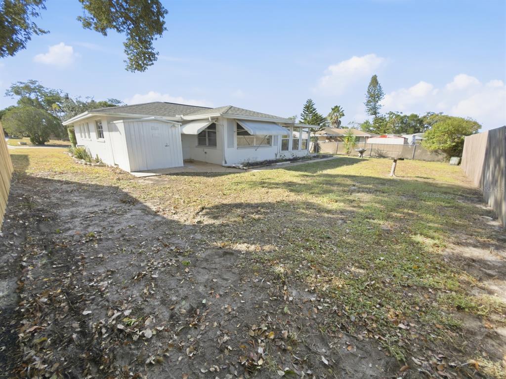7903 Valmy Lane Port Richey, FL 34668 - Photo 35 of 40 a view of a house with backyard porch and patio