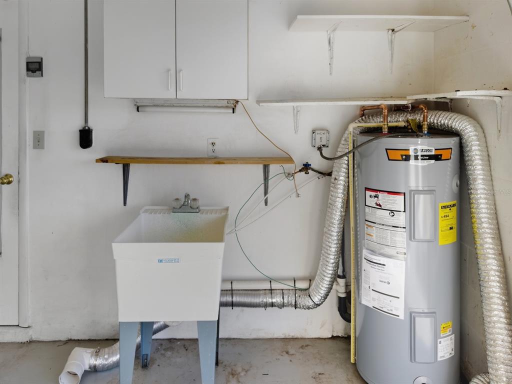 7903 Valmy Lane Port Richey, FL 34668 - Photo 39 of 40 a utility room with dryer and washer