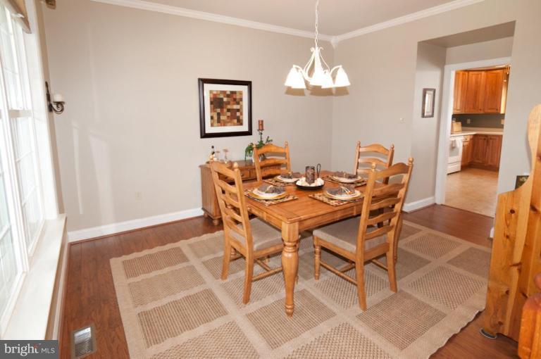4265 Middlepoint Road Myersville, MD 21773 - Photo 8 of 25 a view of a dining room with furniture and chandelier