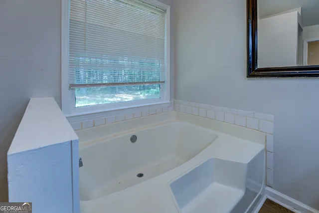 a bathroom with a tub and a window