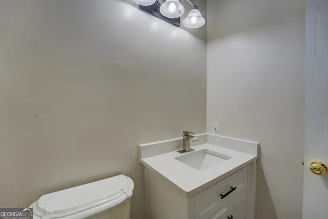 a bathroom with a toilet a sink and mirror