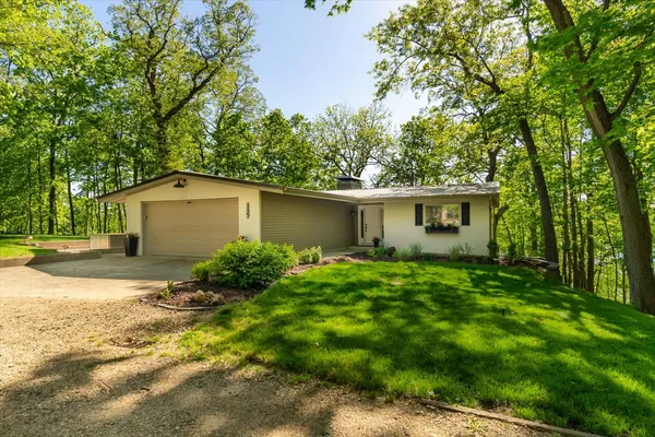 a view of backyard of house with green space