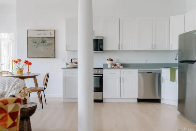 a view of kitchen with furniture and wooden floor