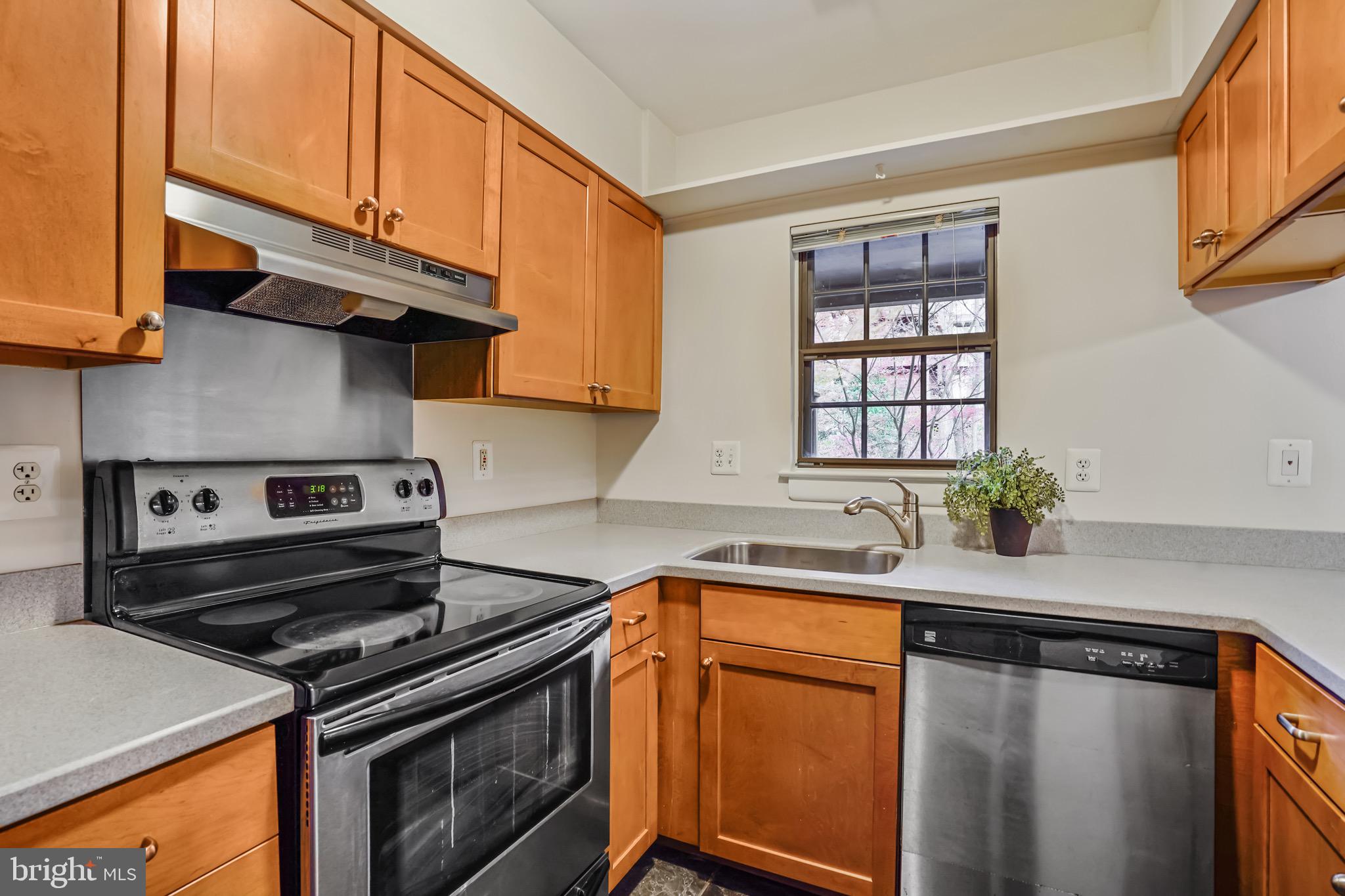 2023 Headlands Circle Reston, VA 20191 - Photo 14 of 44 Kitchen has solid surface counters & wood cabinets