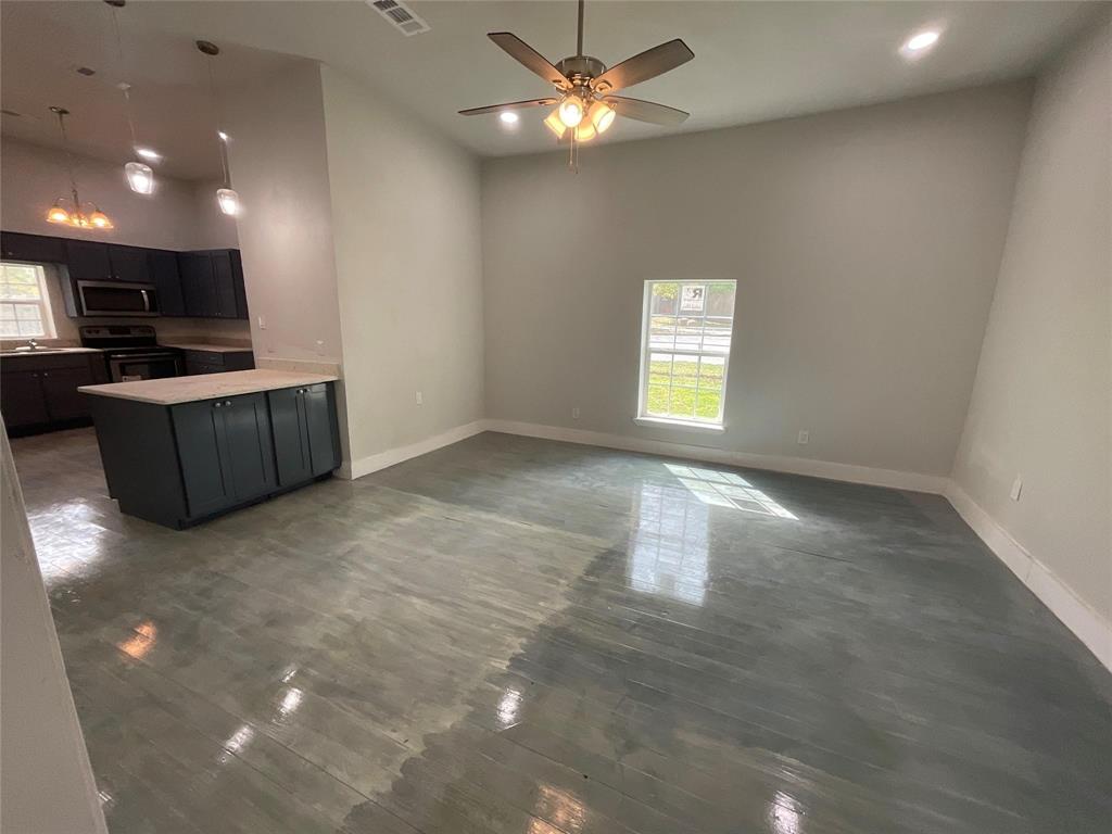 207 College Street Chico, TX 76431 - Photo 15 of 20 Kitchen with light countertops, appliances with stainless steel finishes, recessed lighting, a peninsula, and hanging light fixtures