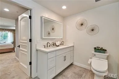 a spacious bathroom with a toilet a sink and glass door