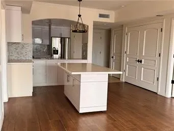 a large kitchen with stainless steel appliances granite countertop a dishwasher a stove and a wooden floors