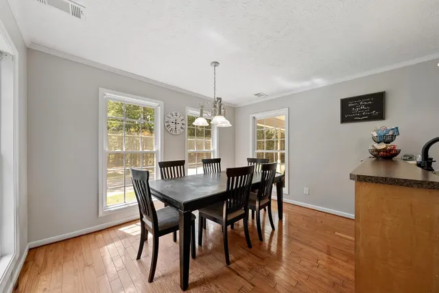 a view of a dining room with furniture window and wooden floor