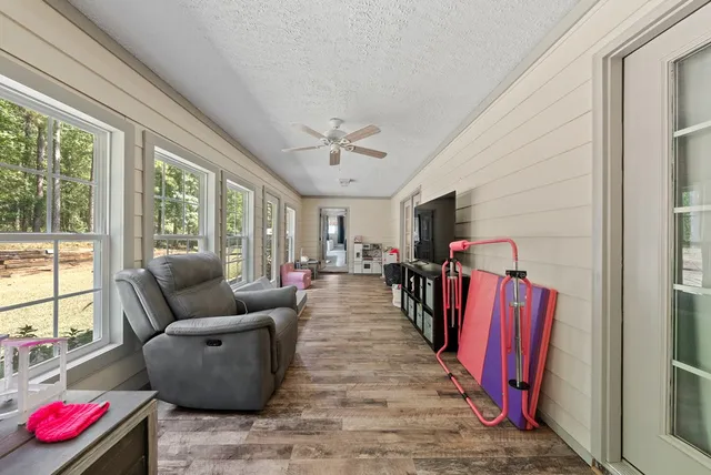 a living room with furniture fireplace and a large window