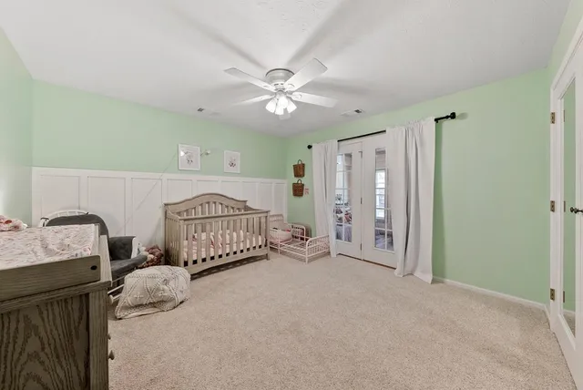 a spacious bedroom with a bed and a chandelier