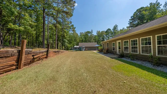 a view of a house with backyard and sitting area