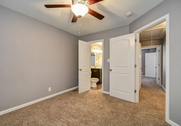 wooden floor in an empty room and a bathroom