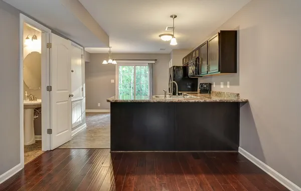 a kitchen with stainless steel appliances granite countertop a sink a stove and a refrigerator
