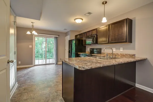 a kitchen with a sink a center island and cabinets