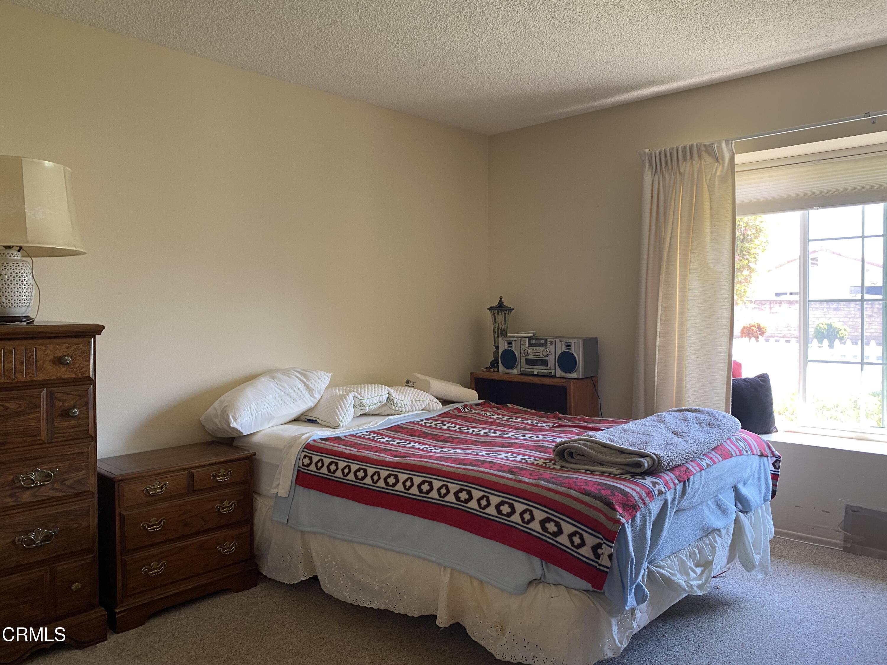 1341 Bottlebrush Place Oxnard, CA 93030 - Photo 12 of 25 a bedroom with a bed and a window