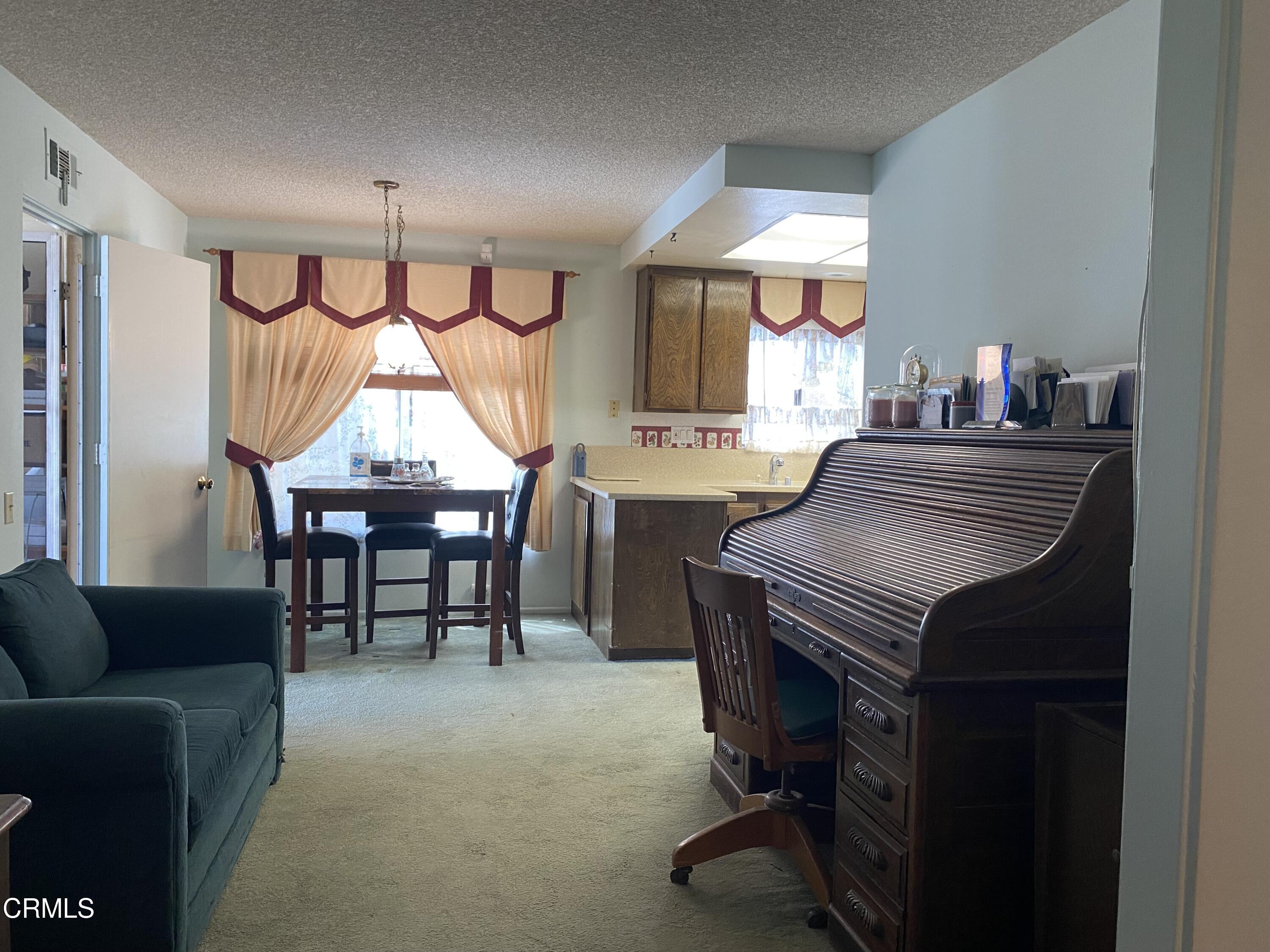 1341 Bottlebrush Place Oxnard, CA 93030 - Photo 4 of 25 a room with furniture a window and a chandelier