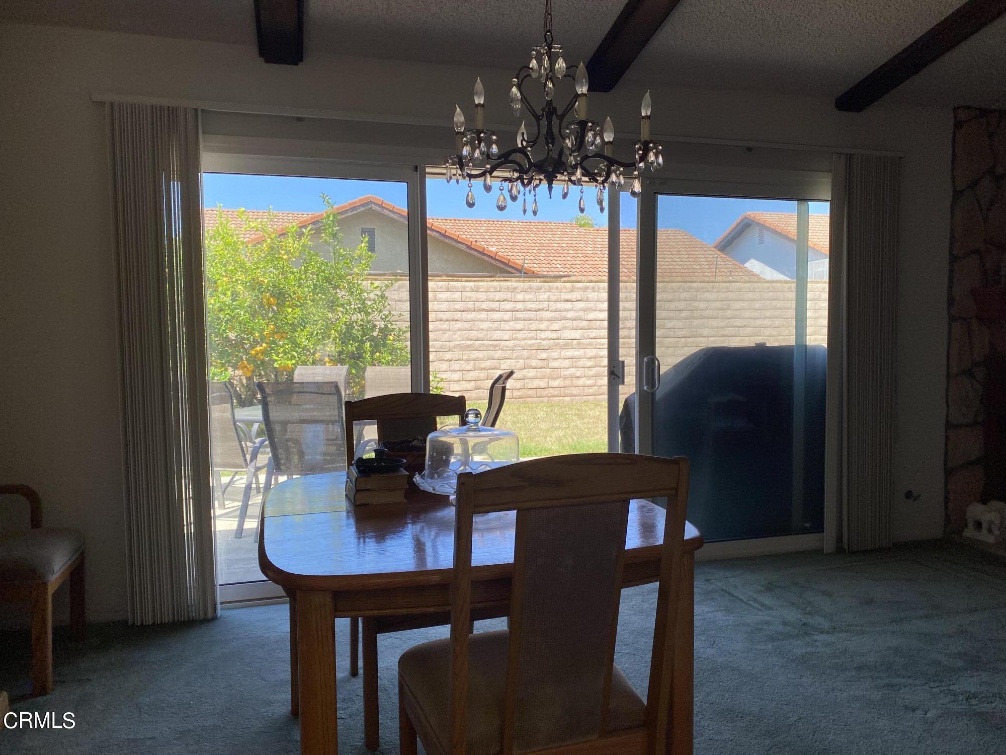 1341 Bottlebrush Place Oxnard, CA 93030 - Photo 5 of 25 a view of a dining room with furniture a chandelier and a window
