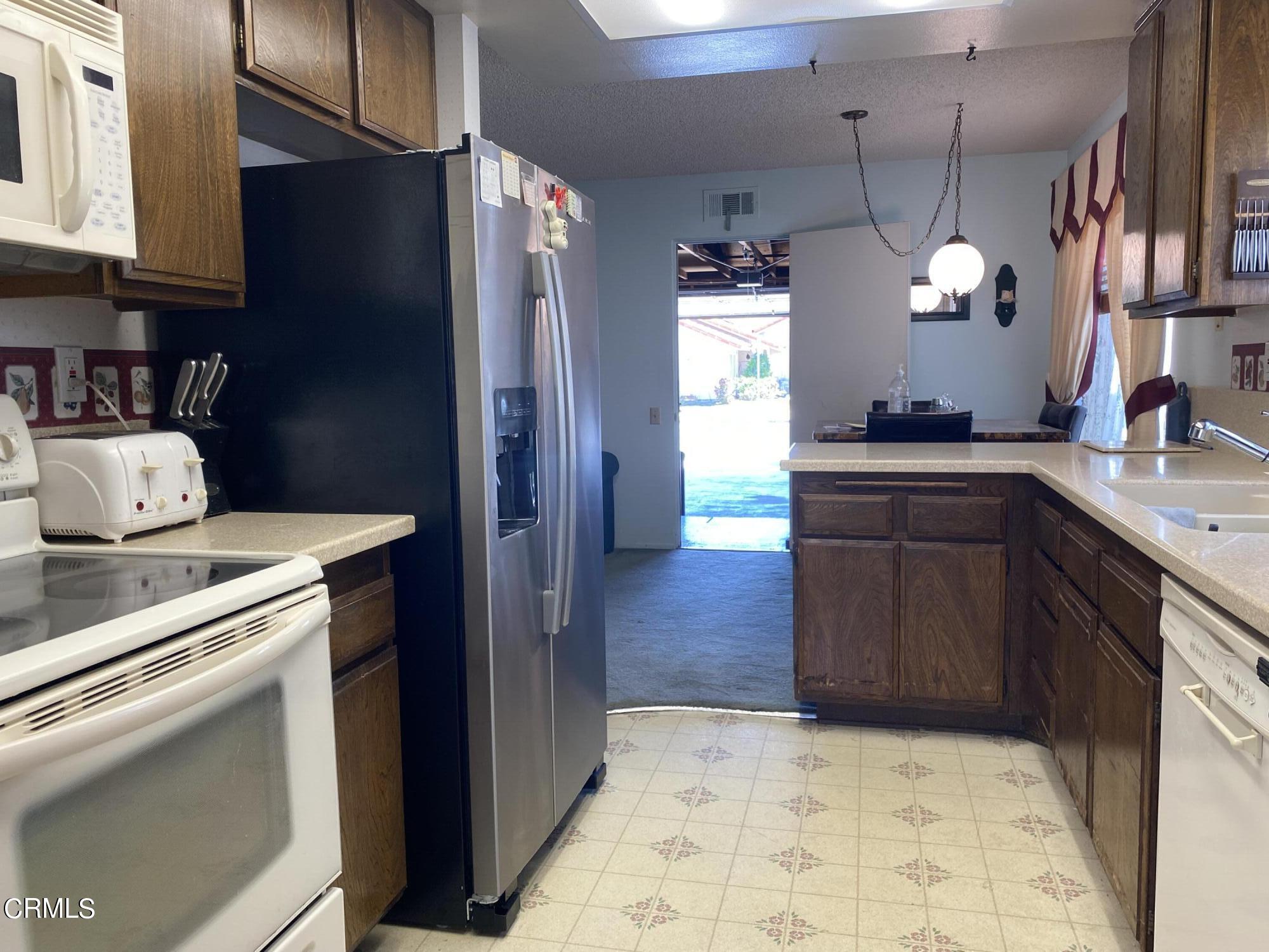 1341 Bottlebrush Place Oxnard, CA 93030 - Photo 7 of 25 a kitchen with a sink and cabinets