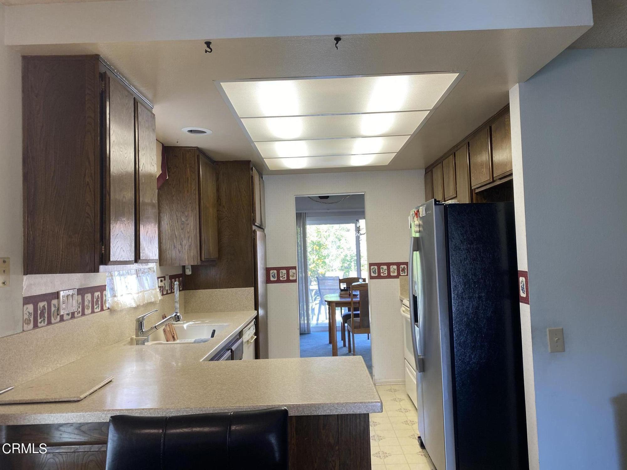 1341 Bottlebrush Place Oxnard, CA 93030 - Photo 10 of 25 a kitchen with kitchen island a sink stove and refrigerator