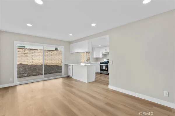 a view of a kitchen with wooden floor